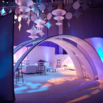 Originators Design of rental portable Wave Walls flanking entry Arches to define an corporate event LOUNGE