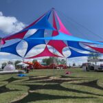 In various colors, The Stiltied Chill shade Structure can be rented for hire from The Originators Design. This fabric shade structure, The Stilted Chill is seen here free standing as rigged Festival decor.