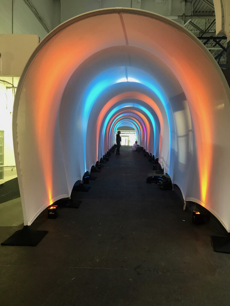 Look at those colors created with light on a white tension fabric rental tunnel