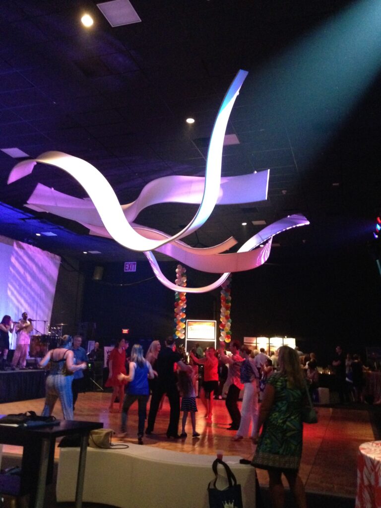 The Originators AirWave ribbons are custom designed to fit each space. These tension fabric ribbon structures are ceiling treatments to enhance that “otherwise uninvolved space.” Look UP!