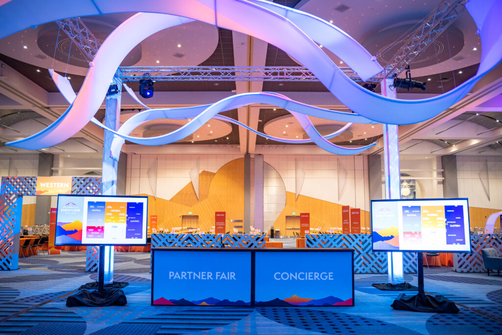 Originators Design Suspended AirWaves are "flexible" ribbons - We create custom designs with our vast inventory for your trade show or events. In this case, DIY, on truss as a grand entryway for the clients' convention