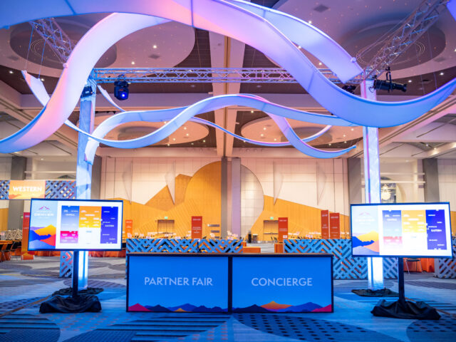 Originators Design Suspended AirWaves are "flexible" ribbons - We create custom designs with our vast inventory for your trade show or events. In this case, DIY, on truss as a grand entryway for the clients' convention
